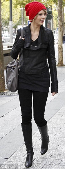 She's in fashion: Swift enjoyed her stroll around the French   capital in an all-black outfit teamed with bright red hat